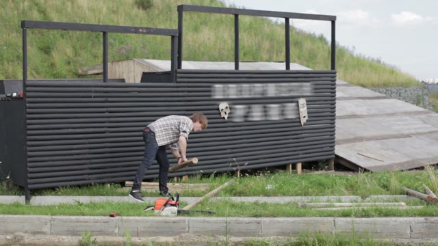 Man Saws Off The Edge Of The Timber