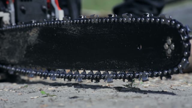 Working Chainsaw On The Ground
