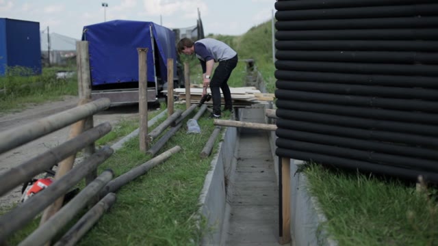 Man Builds A Fence