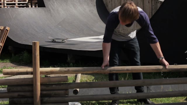 Man Puts Timber On Each Other