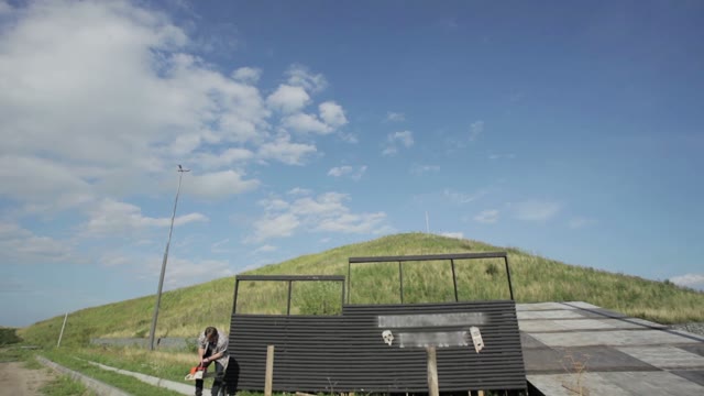 Man Is Building On A Background Of A Hill