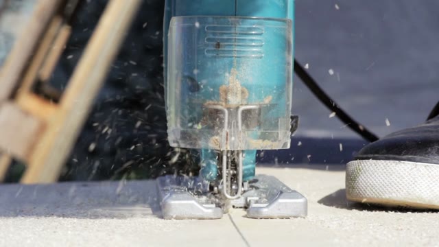 Man Sawing Plank Electric Fretsaw Close-up