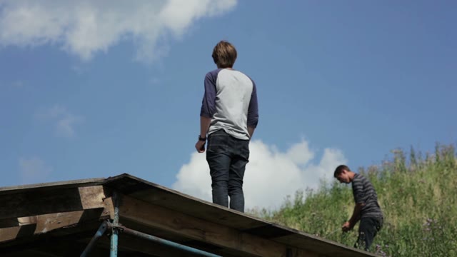 Man Standing On A Wooden Structure On The Outdoor