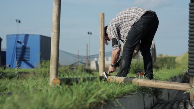 Man Builds A Fence Using A Screwdriver