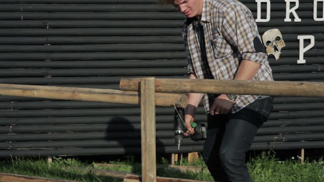 Man Spins Screws On The Fence
