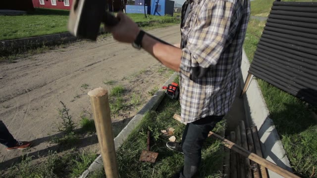 Man Hammers In Stake In The Ground Close-up