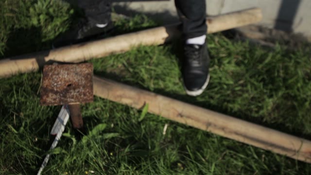 Man Hammers In Ironwork In The Ground