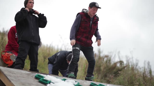 Young Man On A Snowboard Slide