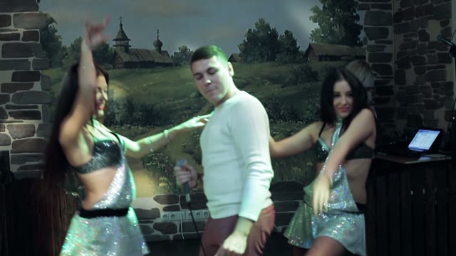 Man Sings And Dances With Two Dancers