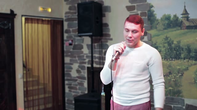 Man Speaks Into A Microphone