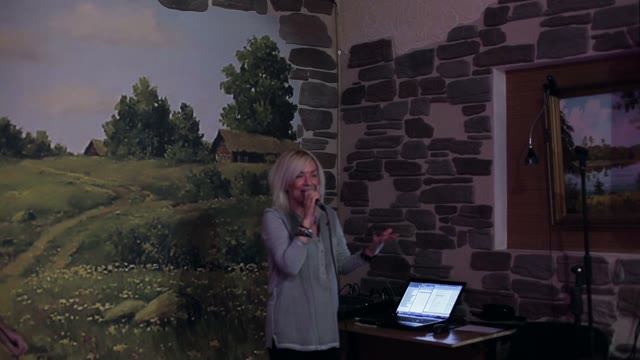 Blonde Woman Speaks Into The Microphone And Smiling
