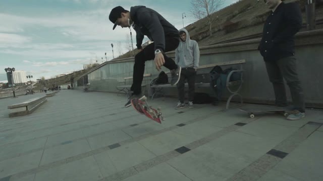 Man Makes A Few Tricks On A Skateboard In The Outdoor