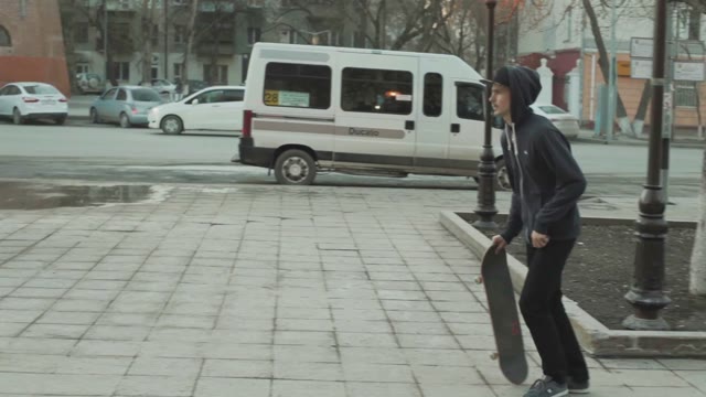 Man Doing A 360 Flip In The Outdoor