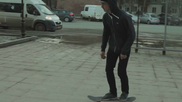 Skateboarder Does A Trick Outdoors