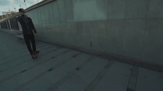 Man Standing With A Skateboard