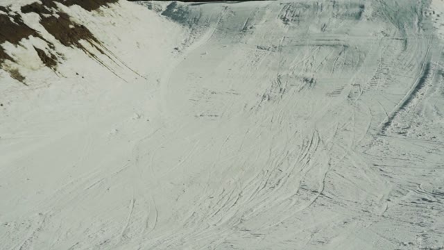 Snowboarder Slides Down From The Snow Slope