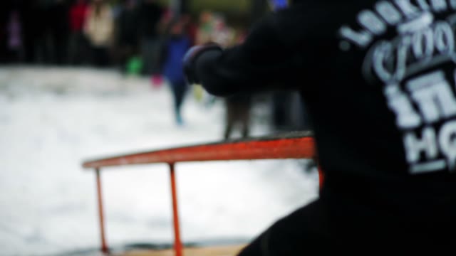 Snowboarder Does The Trick By A Pipe Close-up