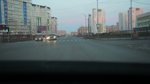 View Through The Car Windshield On Buildings