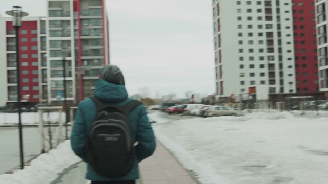 Man Walking Among The Houses