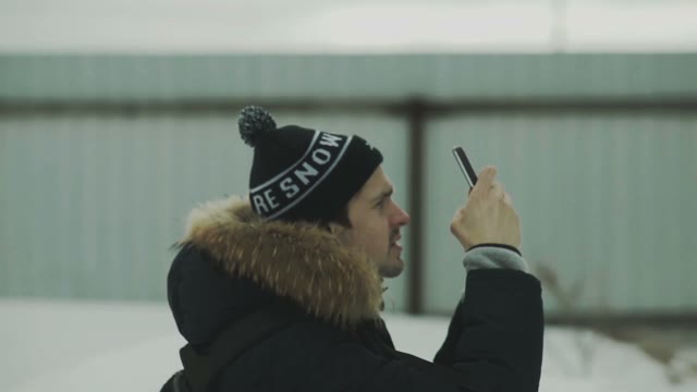 Man Photographing Something On Smartphone