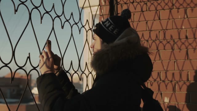 Man Photographing From The Balcony On The Smartphone