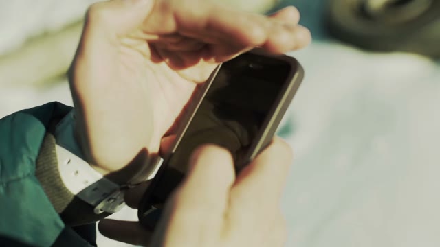 Man Uses A Smartphone Close-up