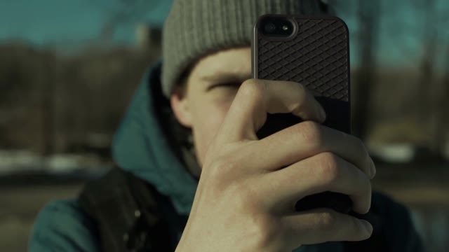 Man Standing With A Smartphone Outdoors Close-up Of Smartphone