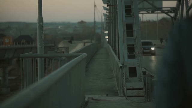 Man Climbs On A Steel Construction On The Bridge