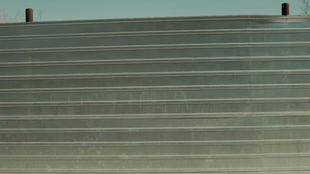 Man Is Walking Past The Iron Fence