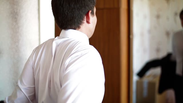 Man Wearing A Jacket In Front Of A Mirror