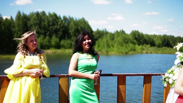 Two Women Standing With Glasses In The Outdoor