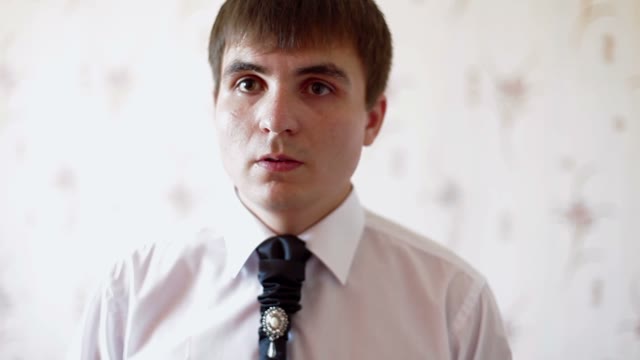 Man Straightens His Tie Close-up