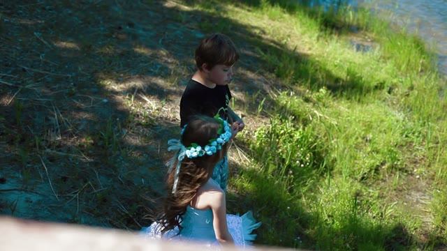 Boy And Girl Talking On The Lake