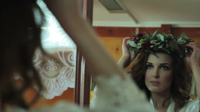 Woman Puts A Wreath On Her Head In Front Of A Mirror