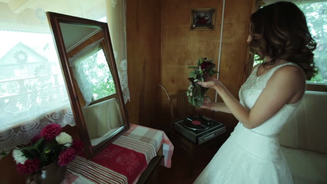Bride Puts On A Wreath In Front Of The Mirror