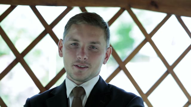 Man In A Suit Tells The Camera Close-up