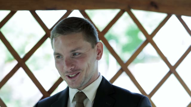 Man In A Suit Tells And Smiles Close-up