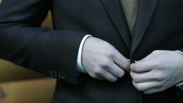 Man Buttons His Jacket Close-up