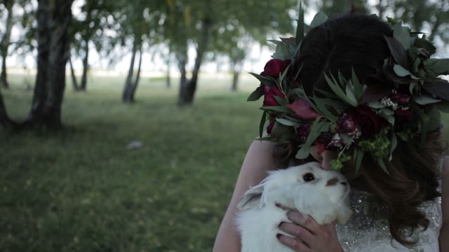 Bride Caressing A Rabbit In The Forest Close-up