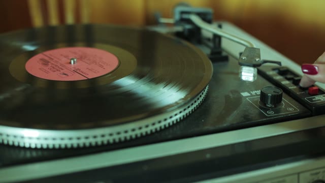 Woman Turned On The Vinyl Player Close-up