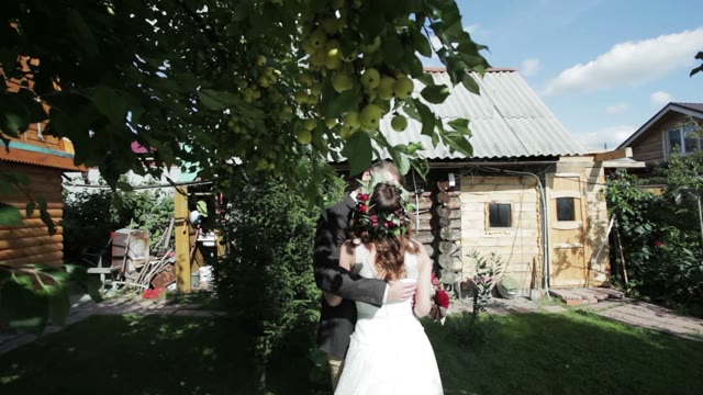 Newlywed Couple Kissing On A Summer Residence