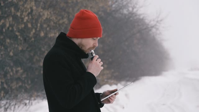Man Smokes Electronic Cigarette. Slow Motion