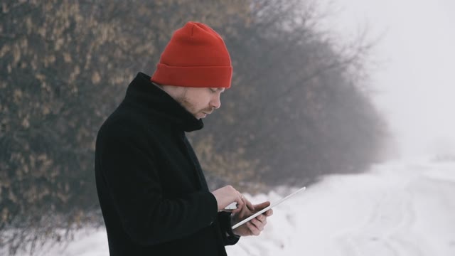 Man Smokes An Electronic Cigarette In The Park. Slow Motion