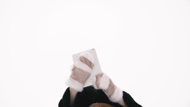 Shooting From The Bottom. A Girl Holding A Tablet In Her Hands