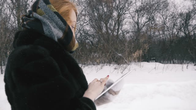 Young Girl Walking In The Park With Tablet.Slow Motion