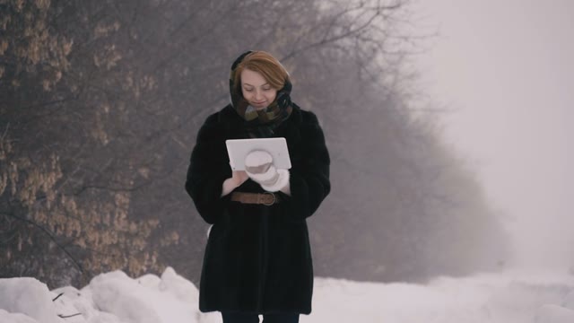 Girl With Tablet Walks In The Park. Slow Motion