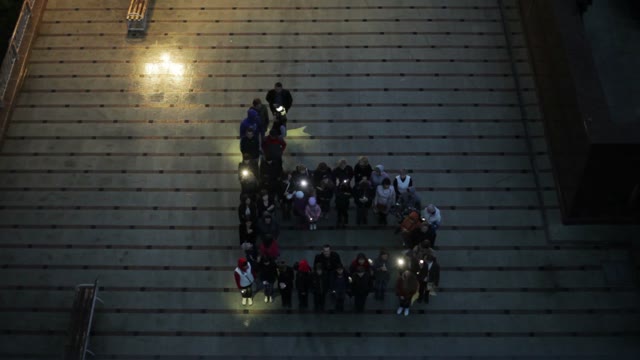 Crowd Standing In The Form Of Letters