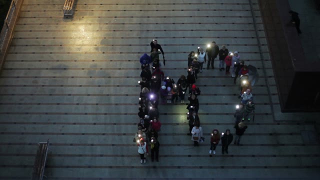 Crowd Standing In The Form Of Letters