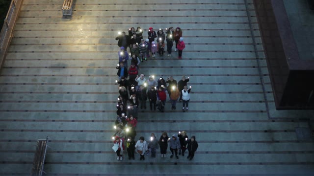 Crowd Standing In The Form Of Letters