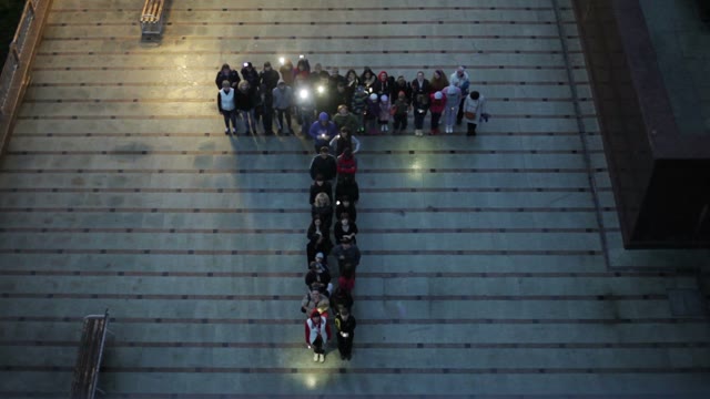 Crowd Standing In The Form Of Letters